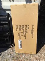 Photo of cardboard box packaging with product details and dimensions
