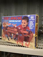 Original sealed box showing Fort Apache Western play set with 95 play pieces and image of child playing