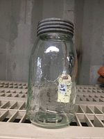 Front view of the antique Imperial quart seal glass jar showing embossed lettering and original metal lid.