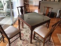 Table and chairs set in room showing all five pieces