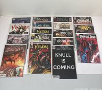 Photo shows 17 Venom comic books arranged in rows, featuring covers with Venom and Carnage characters, all boarded and covered.