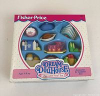 Front of the unopened Fisher-Price Dream Doll House Fun with Food Set box with visible food accessory pieces inside.