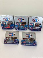 Lot of five 1:64 scale Richard Petty 25th Anniversary STP die-cast NASCAR cars in original packaging, displayed in two rows.