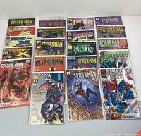 Photo showing 20 Spider-Man comics, neatly arranged in four rows, all boarded and covered.