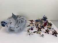 Millennium Falcon playset with 24 Star Wars Galactic Heroes figures placed around it on white surface