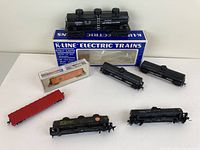 All six model train cars arranged on a table with two K-Line Electric Trains boxes in background.
