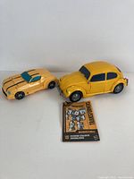 Yellow Volkswagen Beetle Bumblebee Transformer toy car and Camaro car with Bumblebee manual
