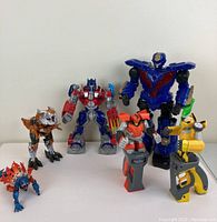 Lot overview with six Transformers and robot action figures shown.