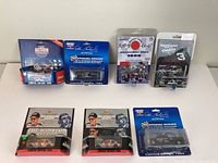 Six limited edition Dale Earnhardt die cast cars in original packaging arranged in two rows, showing various sponsor logos and racing numbers.
