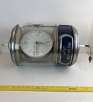Side view of the entire vintage Michelob Light clock sign showing the clock face inside a clear housing with chrome and blue accents.