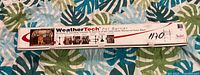 Photo of long rectangular white WeatherTech box with branding, shows product name and partial instructions.
