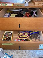 Top drawer containing poker chips, wooden cribbage boards, and small game accessories.