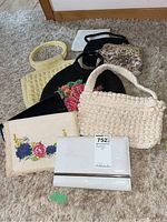 Photo showing nine vintage purses of various styles including woven, beaded, embroidered, and faux leather types