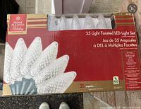 Box front showing Home Accents Holiday brand and 35 Light Faceted LED Light Set text, the white faceted LED bulbs visible through the clear plastic.