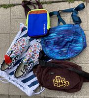 Photo showing four bags and one pair of VANS slip-on shoes.