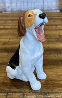 Front view showing the dog yawning, painted realistically in tri-color pattern