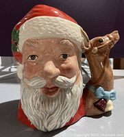 Front view showing Santa Claus face and reindeer handle