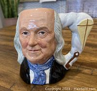 Front close-up view of Royal Doulton Toby Jug featuring Benjamin Franklin's face, showing detailed painting and facial expression.