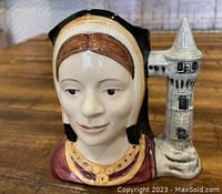 Front view of Royal Doulton Toby Jug depicting Catherine of Aragon with the tower handle.
