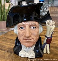 Front view of the Royal Doulton Toby Jug featuring George Washington, showing detailed facial features and the hat decoration.