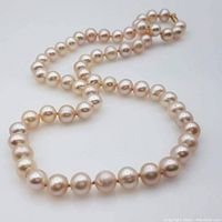 Pearl necklace laid out showing pearl strand and clasp details.