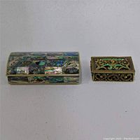 Both jewelry boxes shown side by side on a flat light surface for scale and detail.