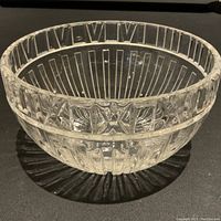 Clear large crystal bowl with vertical ridges and an Atlas lettered band around the top edge, shown side angle view.