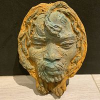 Front view of the artist-made pottery profile sculpture showing the detailed human face with layered textured hair and beard
