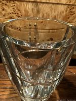 Close-up image showing the thick crystal rim with noticeable small chip damage along the edge