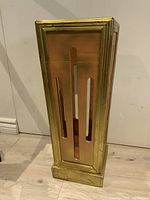 Front view of the vintage Florentine umbrella stand with brass frame and copper panels showing vertical slots