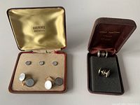 Photo showing two sets of sterling silver cuff links in their original cases, one from Krementz Heraldic and one from Sphere Jewelers.