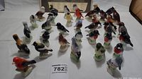 Overview of multiple ceramic bird figurines from the Tender Leaf Canadian bird collection, showing species variety and colors.
