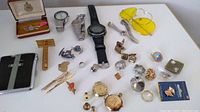 Full lot overview showing all items including watches, pin, lighter, sunglasses, razor, and small accessories.
