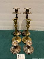 Front view of six candle holders showing all three styles and sizes arranged in rows