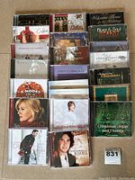 Overview of 24 Christmas themed music CDs from various artists including Kelly Clarkson, Sarah McLachlan, Michael Bublé, Josh Groban and others.