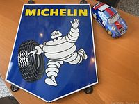Front view of Michelin sign showing logo, Michelin Man and mounting tabs