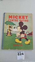 Front cover of the vintage French Mickey Mouse book 'Mickey Contre Ratino' showing Mickey Mouse and Ratino with publisher Hachette marked