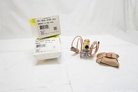 Two thermostatic expansion valves with copper sensing bulbs and capillary tubes, shown outside their original boxes.