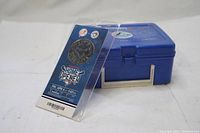 Blue metal Toronto Blue Jays lunch box with matching blue cup and Home Opener ticket on white background