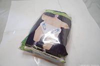 Packaged Gemmy Sumo Baby Inflatable Adult Costume in a clear plastic bag showing the folded costume with the sumo wrestler baby design visible.