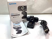 Photo showing Safari ProNNECT 1080p webcam alongside user manual and retail box.
