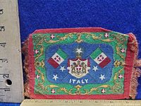 Front side of the antique cigarette felt with Italian flags and coat of arms on blue background with red trim and gold ornamental border.