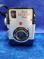 Front view of Kodak Brownie Bull's Eye Camera showing Kodak Twindar Lens, 'Brownie Bull's-Eye Camera' branding, and shutter speed markings.