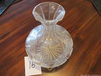 Top view of the clear pressed glass wine decanter showing flared opening and detailed starburst and floral pressed glass patterns.