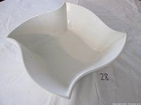 Top view showing the wave edging and overall shape of the white pottery bowl.