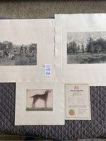 Three etchings laid out on grey quilted fabric with a document related to the dog etching