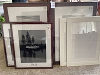 Five picture frames grouped showing three dark wood tone frames with Aaron Brothers brand info visible, and two white frames on right side.