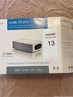 Original packaging box with Elgato EyeTV 250 Plus branding and product description visible