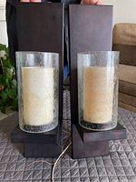 Full view of pair of bronze finish wall sconces with seeded glass and alabaster inset showing size and design.