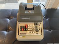 Overview of the Lagomarsino-Totalia printing calculator showing paper roll, keypad, and body condition.